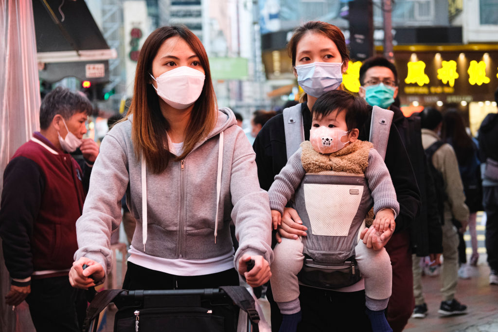 People wear protective mask and walk on the street on December 15, 2020 in Hong Kong, China. (Sawayasu Tsuji–Getty Images)