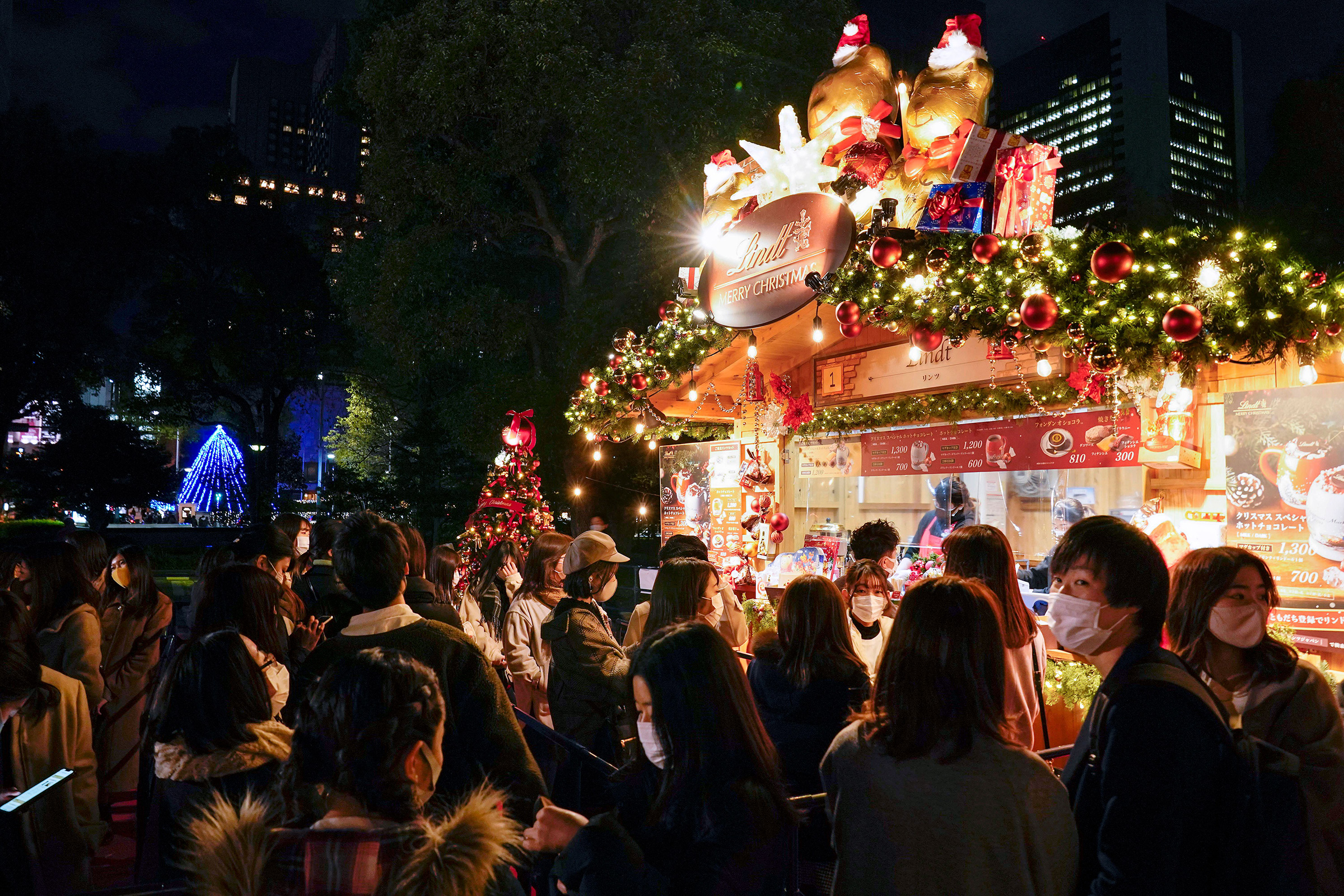 Visitors wearing protective masks enjoy their time at a Christmas market in Tokyo on Dec. 16 after Tokyo government announced it marked its highest record of 678 new COVID-19 infection cases in a day (Kimimasa Mayama—EPA-EFE/Shutterstock)
