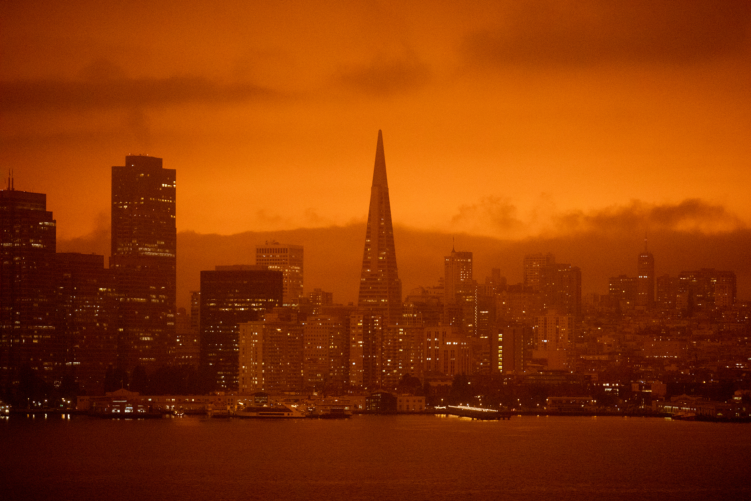 Dark orange skies hang over the San Francisco skyline, as seen from Treasure Island, on Sept. 9, due to multiple wildfires burning across California and Oregon.
