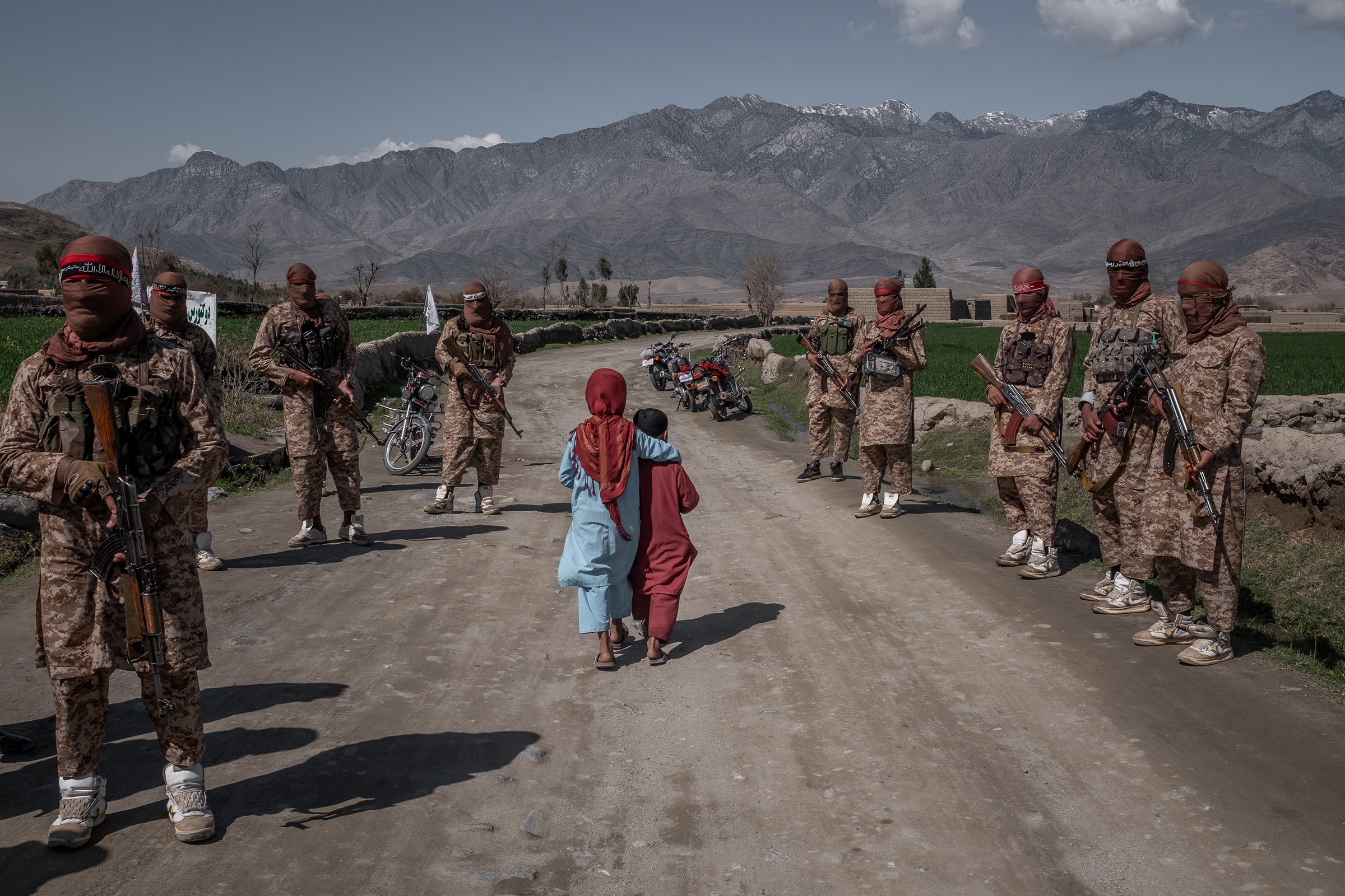 Two children pass members of a Taliban Red Unit, an elite force, in the Alingar District of Afghanistan's Laghman Province in Afghanistan on March 13.
