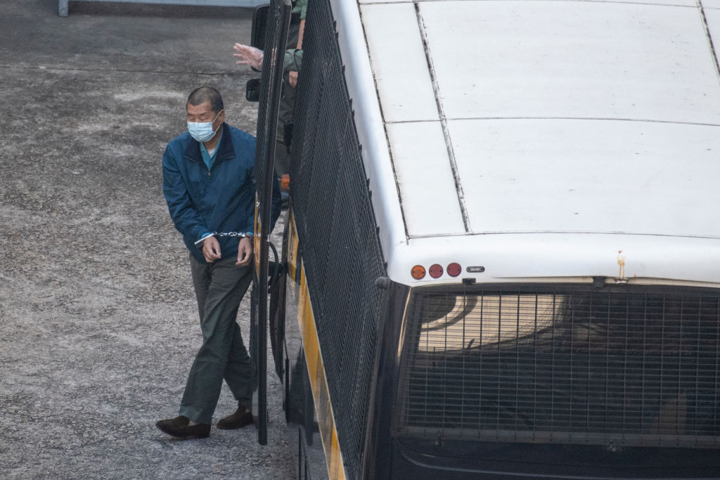 Jimmy Lai is seen handcuffed as he exits a prison van at Lai Chi Kok Reception Center on December 3, 2020 in Hong Kong, China. Jimmy lai was arrested for fraud and was denied bail today at a court hearing. (Vernon Yuen–NurPhoto/Getty Images)
