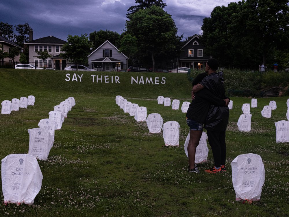 In Minneapolis on June 5, mourners embrace in front of mock headstones at a makeshift memorial in tribute to people killed by the police.