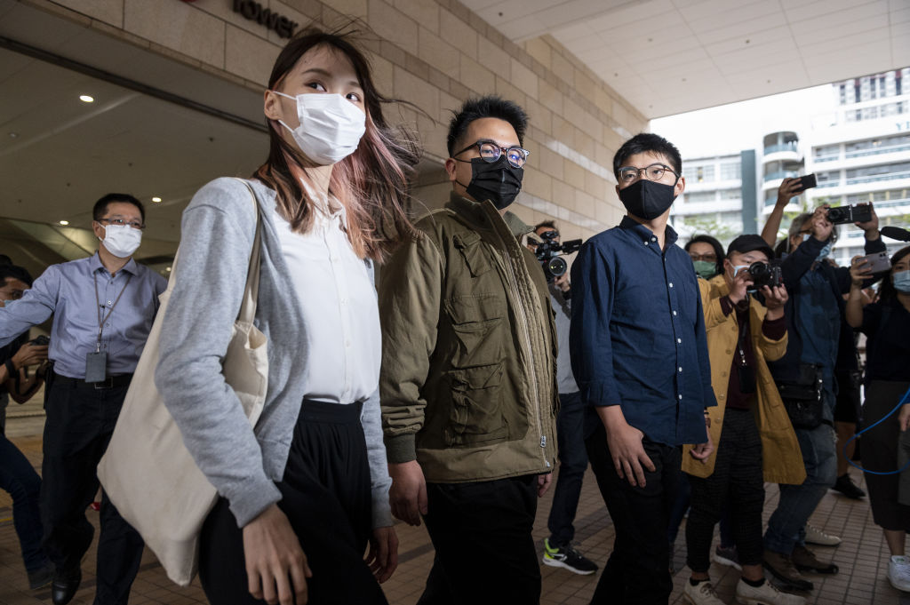 Agnes Chow (L), Ivan Lam (C), and Joshua Wong (R) arrive at the West Kowloon Law Courts building on Nov. 23, 2020 in Hong Kong. (Miguel Candela Poblacion—Anadolu Agency/Getty Images)