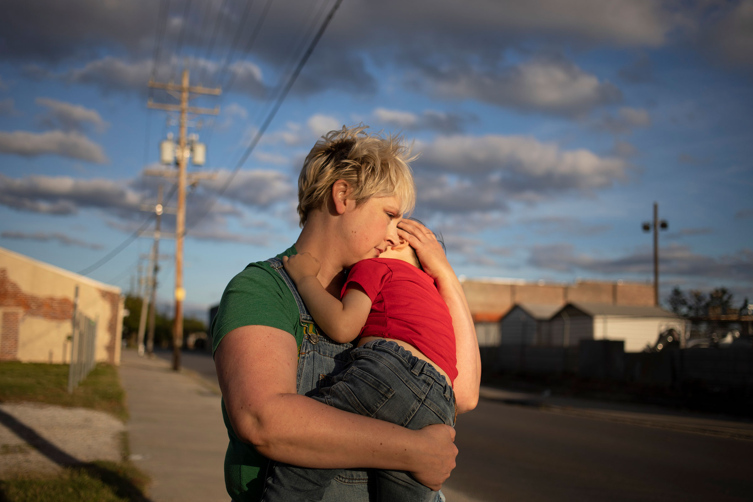Laurie Halbrook, a <a href="https://time.com/collection/coronavirus-heroes/5816899/nurse-family-coronavirus/" target="_blank" rel="noopener noreferrer">registered nurse</a>, holds her son Michael, 3, during a walk through their neighborhood in New Orleans. (Kathleen Flynn for TIME)