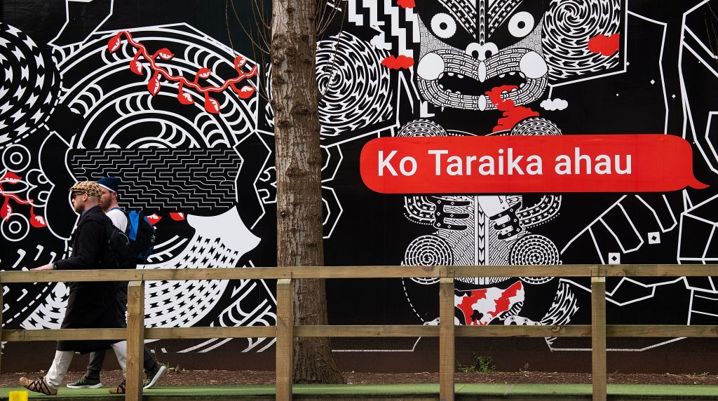 People walk past Maori language signs in Wellington, New Zealand, on Sept. 13, 2018. (Marty Melville—AFP/Getty Images)