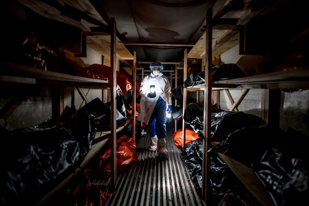 Kyle Edwards, 39, collects lanterns from inside a temporary morgue outside the Wyckoff Heights Medical Center on April 22. Edwards, whose job sometimes involved moving bodies of COVID-19 victims to the morgue, worked 7 a.m. to 10 p.m. shifts during the worst of the pandemic and, like many members of his team, contracted the virus. His family asked him to take time off until the virus died down, but Edwards kept working. He and his wife trained their 5-year-old son to not hug him immediately when he gets home: “Daddy has to wash the coronavirus off him when he gets home from the hospital,” the boy will tell others.