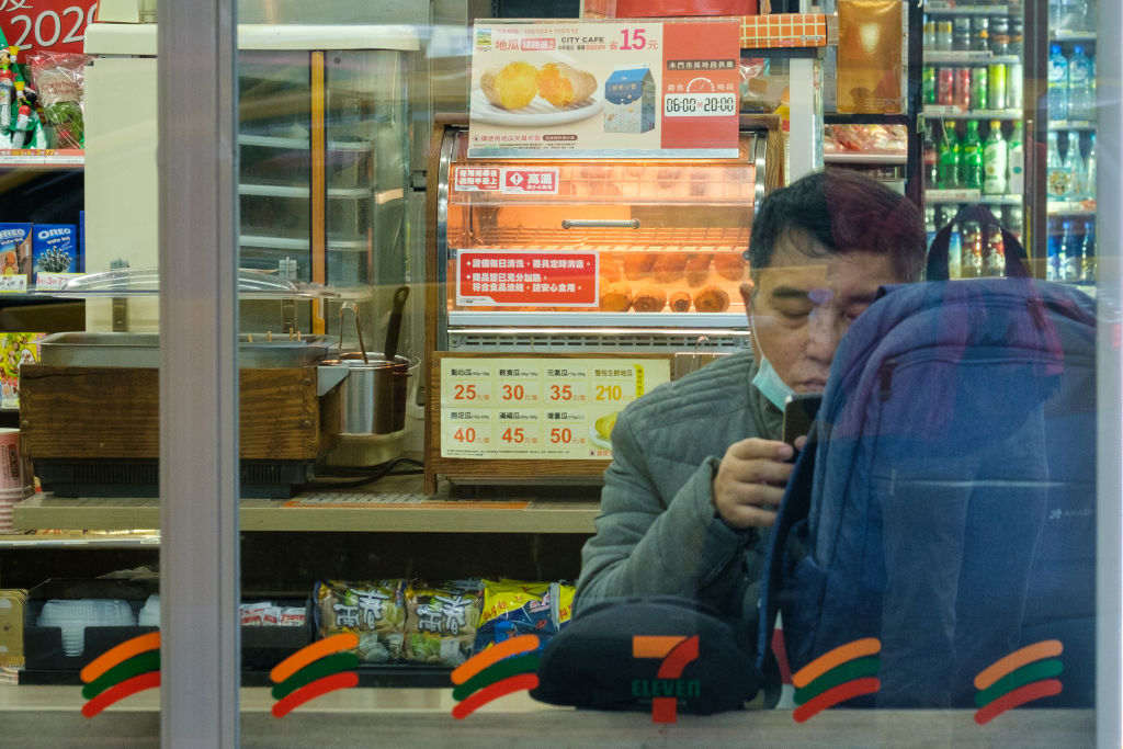 A man wearing a face mask checks his phone in Taipei, Taiwan on December 09, 2020. (Walid Berrazeg–Anadolu Agency/Getty Images)