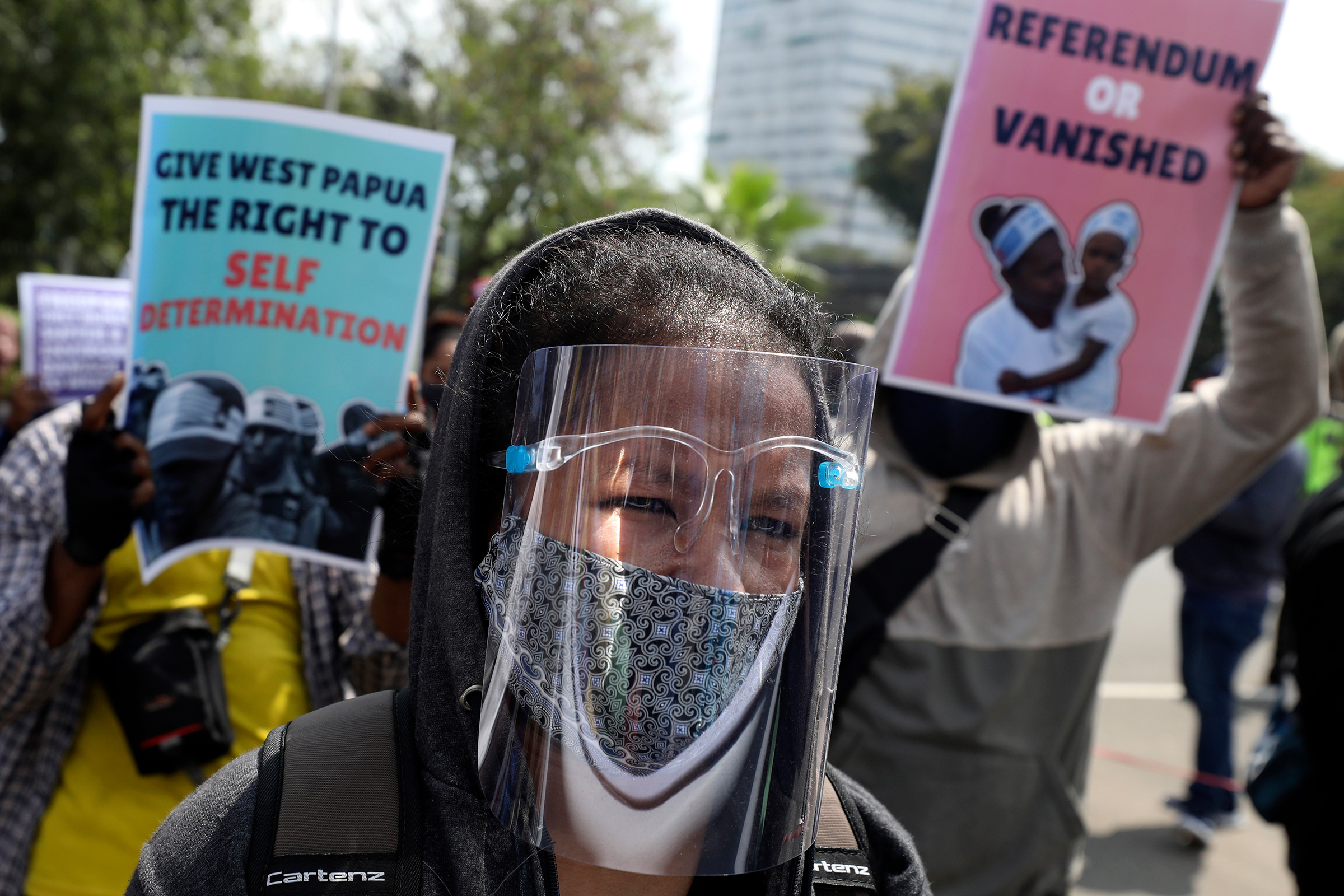 A Papuan pro-independence supporter wears a face shield during a rally commemorating the 58th anniversary of the New York Agreement outside the U.S. Embassy in Jakarta on Aug. 15. The agreement, signed by the Netherlands and Indonesia in 1962, led to Indonesia taking over West Papua from Dutch colonial rule in 1963