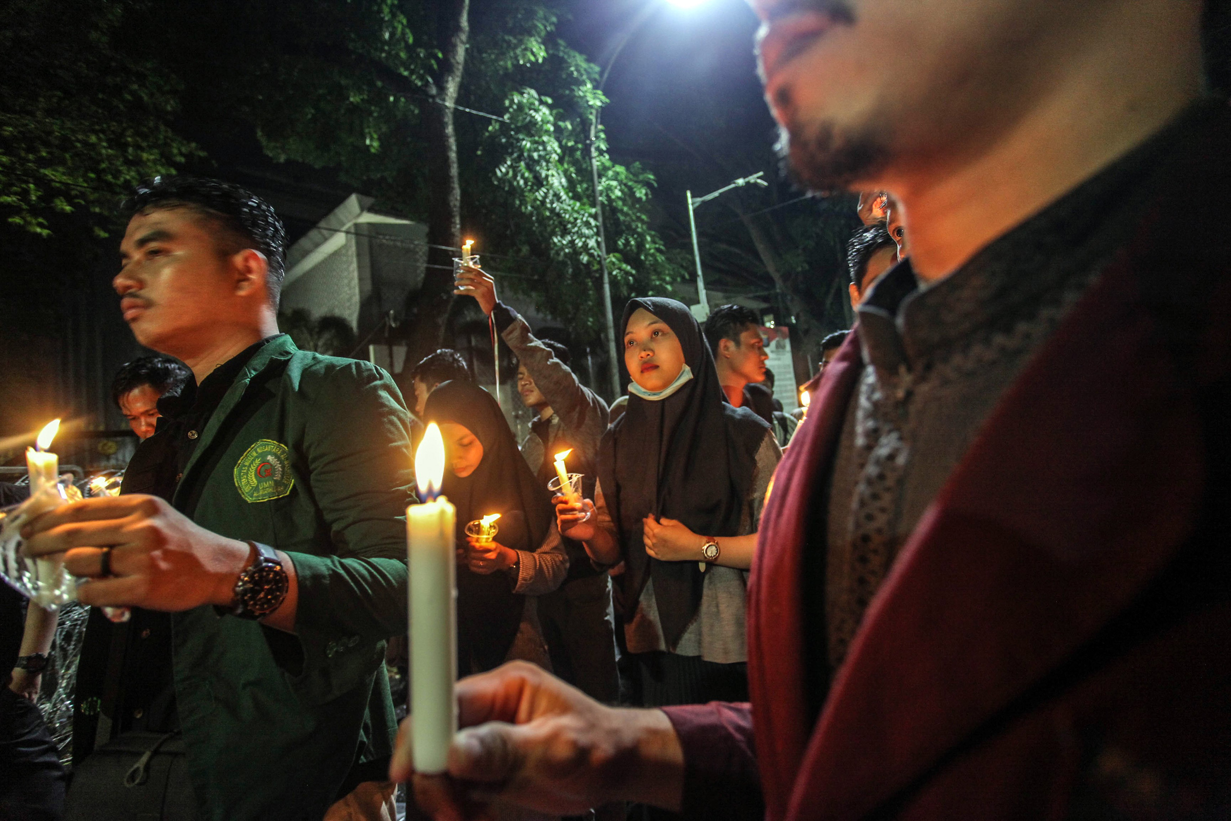 Indonesian students hold candles during a protest in Medan, Indonesia on Oct. 1, 2019 against the government's proposed change in its criminal code laws, plans to weaken the anti-corruption commission and riot victims in Wamena (Albert Ivan Damanik—Anadolu Agency/Getty Images)