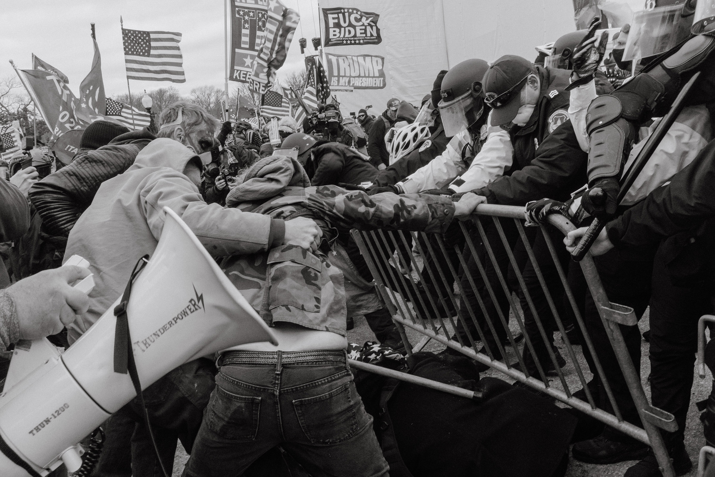 Pro-Trump rioters push through a barrier outside of the Capitol building.. (Christopher Lee for TIME)