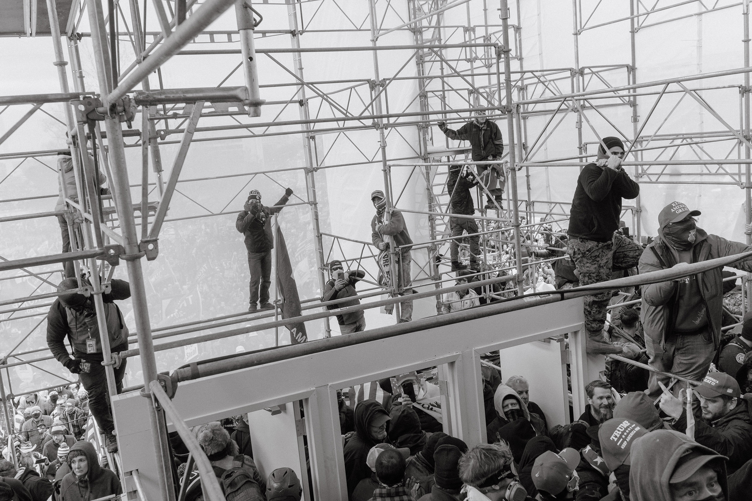 Pro-Trump rioters climb the scaffolding outside of the Capitol. (Christopher Lee for TIME)