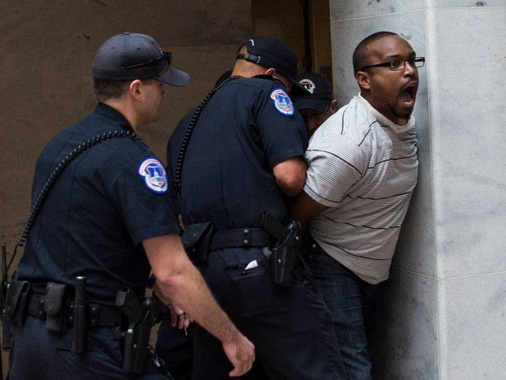 US Capitol Police arrest a protestor as Judge Brett Kavanaugh testifies during the second day of his US Senate Judiciary Committee confirmation hearing to be an Associate Justice on the US Supreme Court, on Capitol Hill in Washington, DC, September 5, 2018. (Andrew Caballero—AFP/Getty Images)
