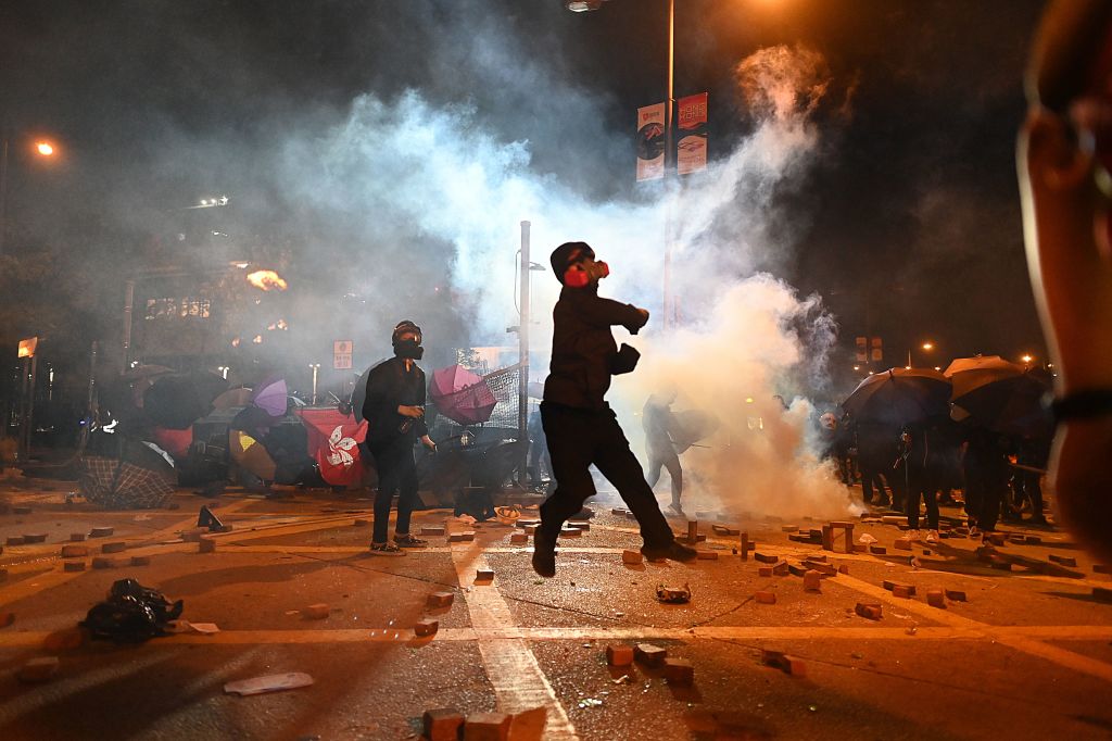 A protestor throws a petrol bomb during clashes with police outside the Polytechnic University of Hong Kong in Hung Hom district of Hong Kong on November 16, 2019. (YE AUNG THU/AFP via Getty Images)