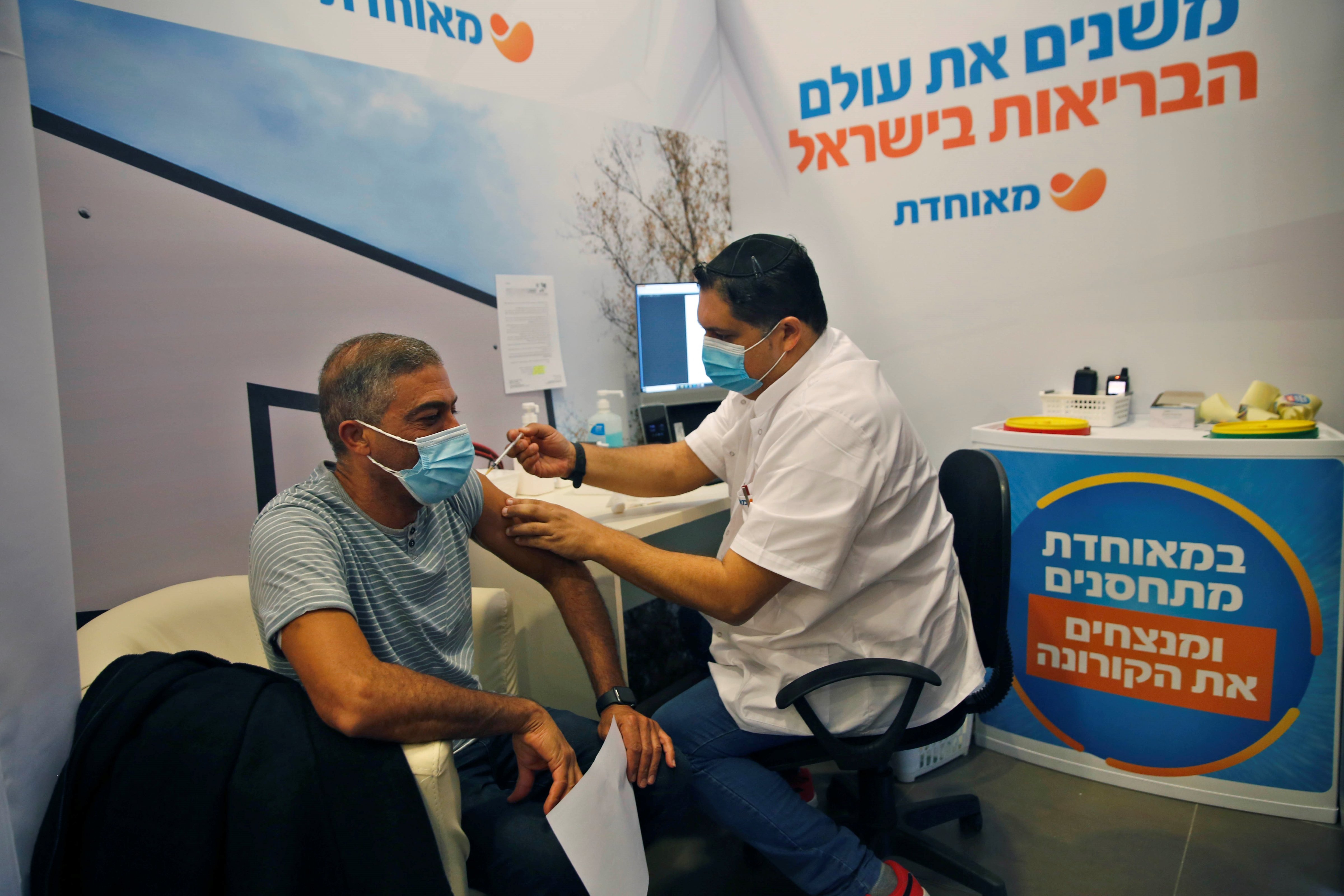 A man receives a COVID-19 vaccine at a health services center in Rehovot, central Israel, on Jan. 14, 2021. (Gil Cohen Magen—Xinhua News Agency/Getty Images)