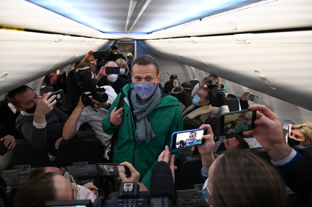 Russian opposition leader Alexei Navalny walks to take his seat in a Pobeda airlines plane heading to Moscow before take-off from Berlin Brandenburg Airport (BER) in Schoenefeld, southeast of Berlin, on Jan. 17, 2021 (Kirill Kudryavtsev—AFP via Getty Images)