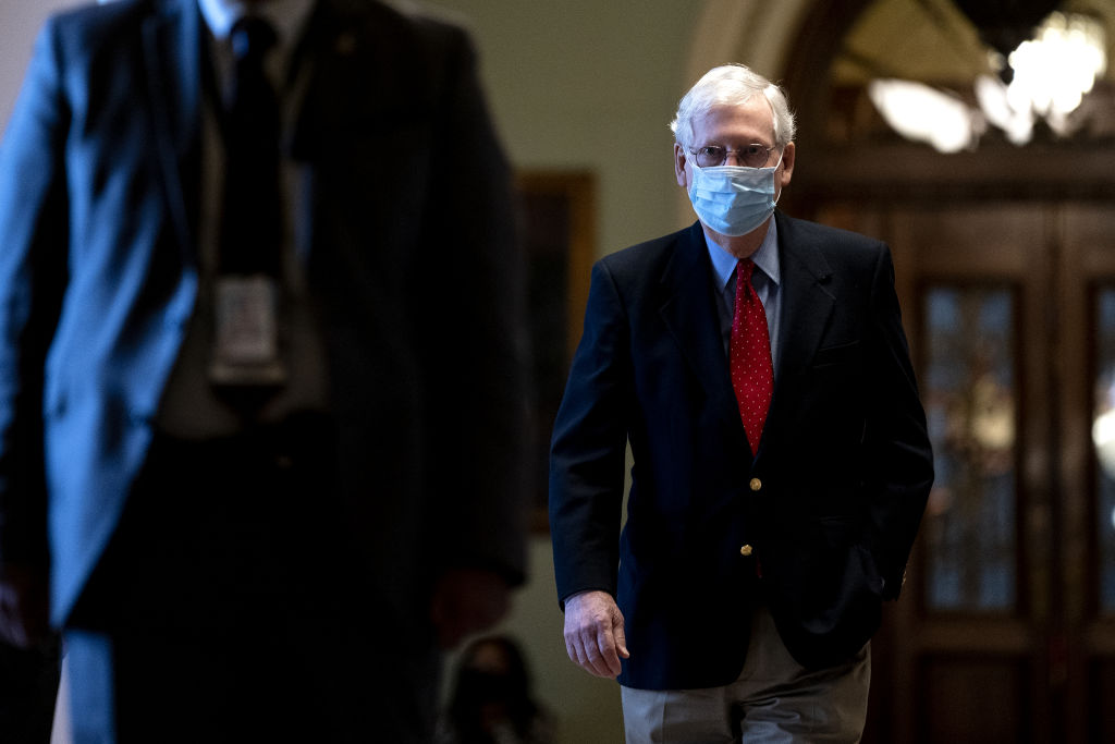 Senate Minority Leader Mitch McConnell, a Republican from Kentucky, right, wears a protective mask while walking to his office from the Senate Chamber at the U.S. Capitol in Washington, D.C., on January 22, 2021. (Stefani Reynolds—Bloomberg/Getty Images)