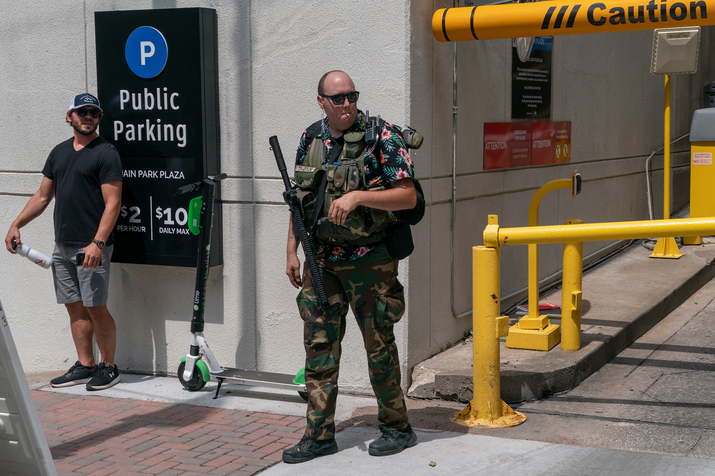 <strong>Tulsa, June 20, 2020.</strong> A Boogaloo Boi carries a rifle outside the BOK Center before Trump's rally. (Peter van Agtmael—Magnum Photos for TIME)