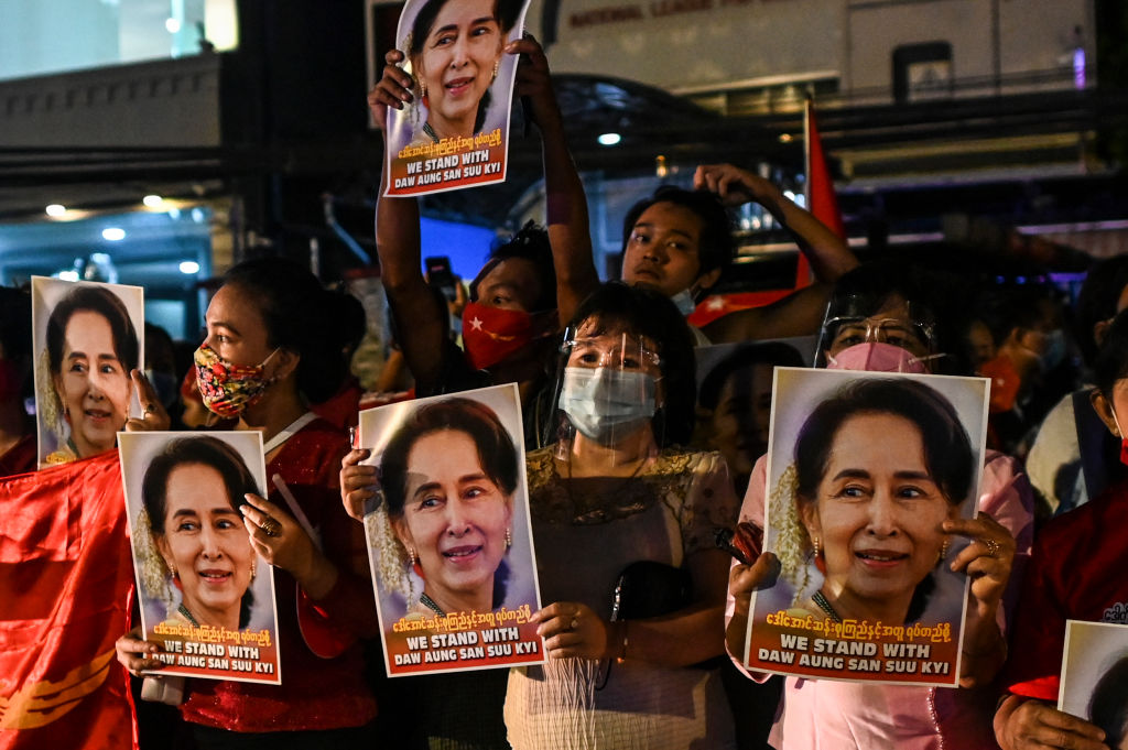 Supporters of the National League for Democracy (NLD) party hold posters with the image of Myanmar state counsellor Aung San Suu Kyi as supporters celebrate in front of the party's headquarters in Yangon on November 9, 2020, as NLD officials said they were confident of a landslide victory in the weekend's election. (Ye Aung Thu—AFP/ Getty Images)