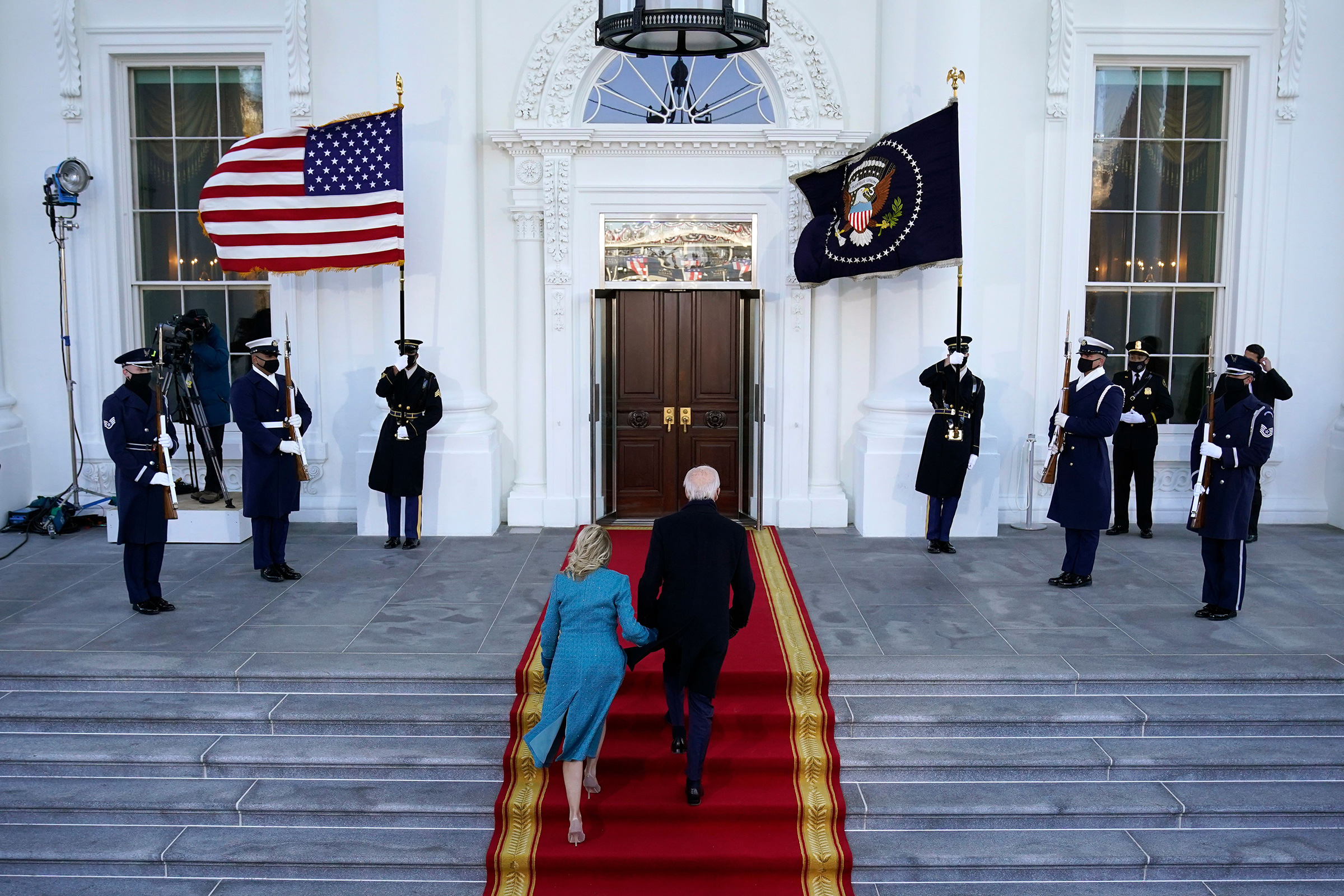 President Joe Biden and first lady Dr. Jill Biden walk up the stairs as they arrive at the North Portico of the White House.