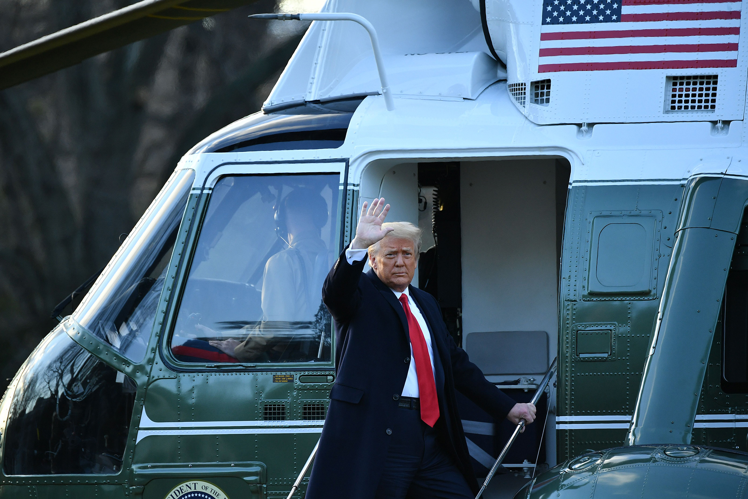 Outgoing President Donald Trump waves as he boards Marine One at the White House in Washington, D.C., on Jan. 20. (Mandel Ngan—AFP/Getty Images)