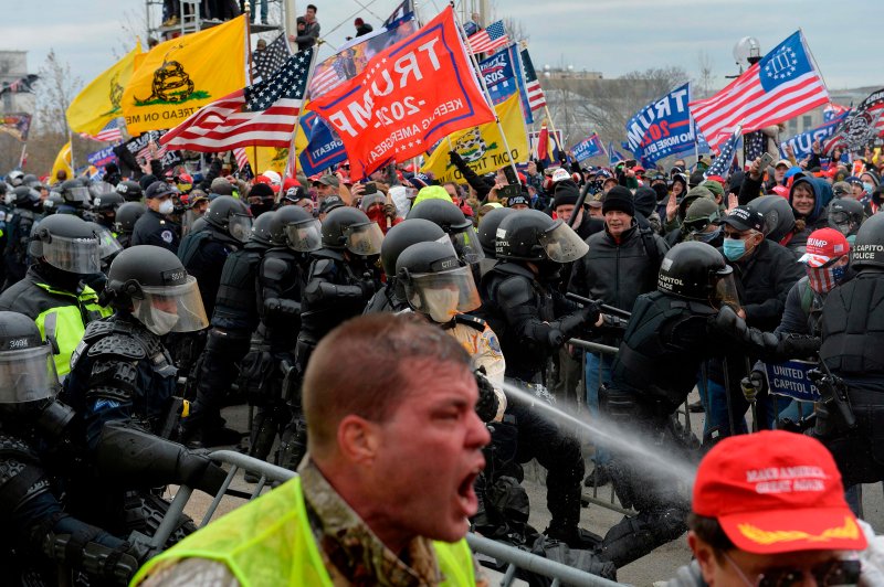 Trump supporters clash with police and security forces as people try to storm the Capitol building in Washington D.C. on Jan. 6, 2021.