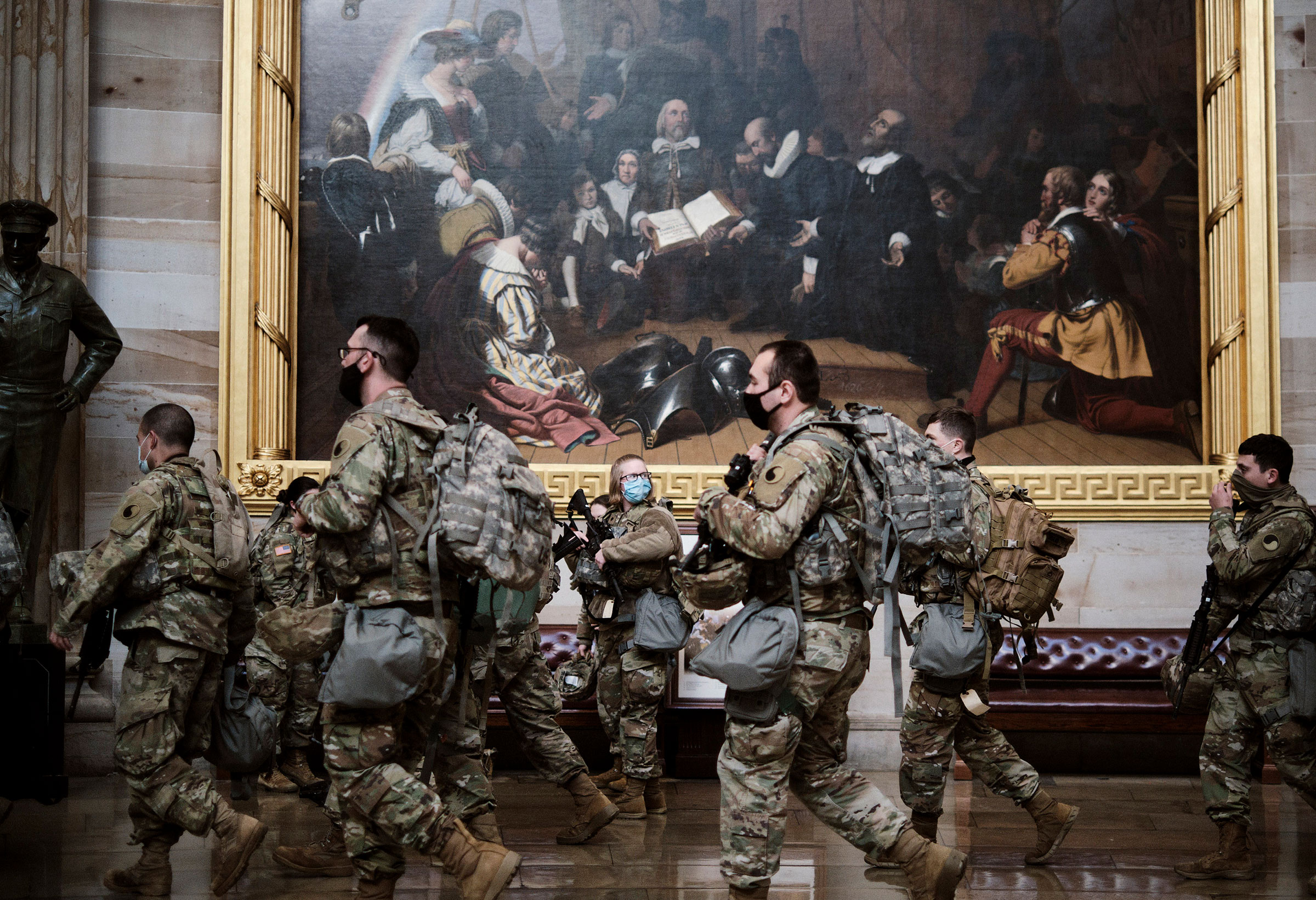 Armed National Guard troops gather in the rotunda of the Capitol in Washington on Wednesday, Jan. 13, 2021. (T.J. Kirkpatrick/The New York Times)