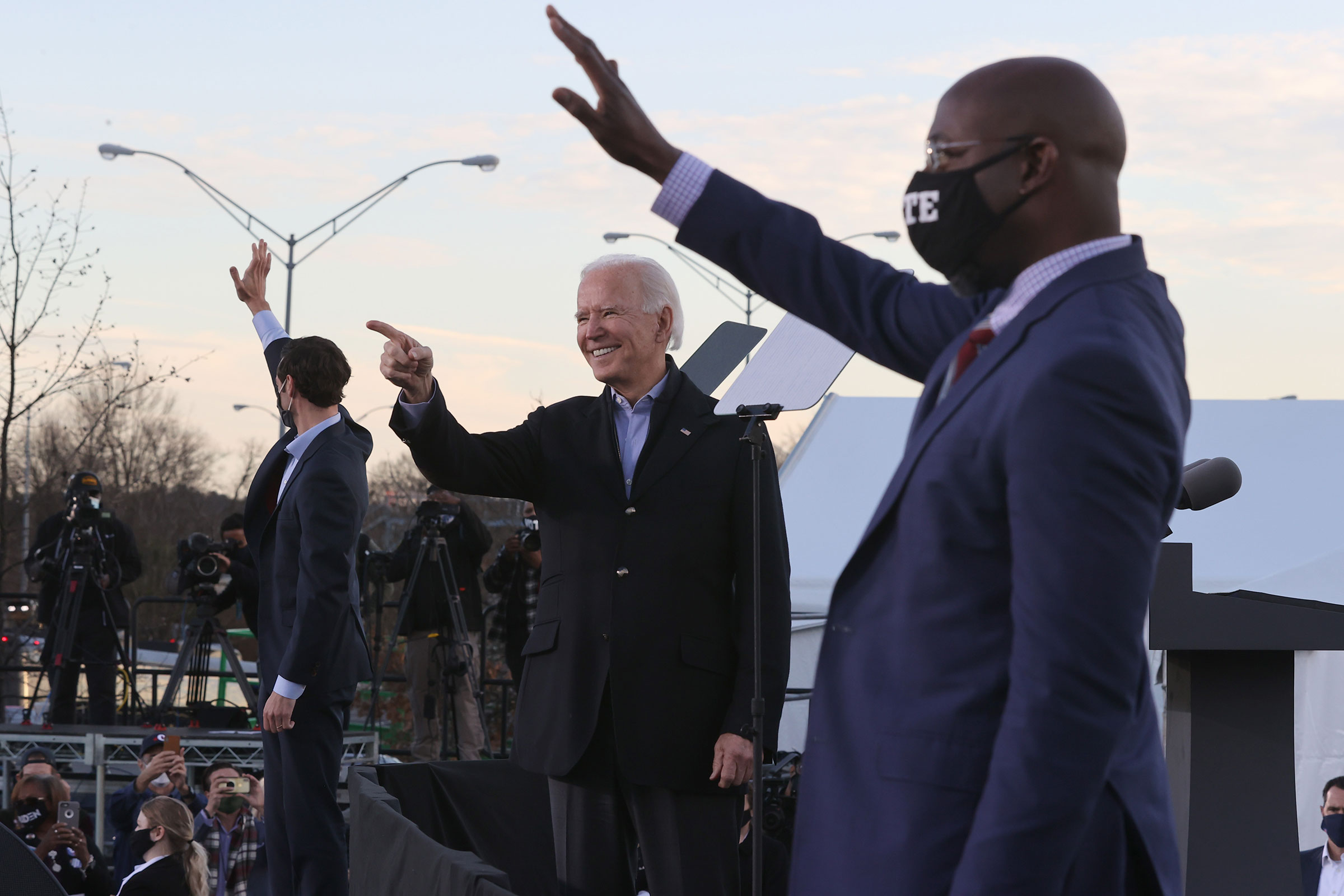 President-elect Joe Biden along with democratic candidates for the Senate Jon Ossoff and Rev. Raphael Warnock greet supporters during a campaign rally the day before their runoff election in Atlanta, on Jan. 04, 2021. (Chip Somodevilla—Getty Images)