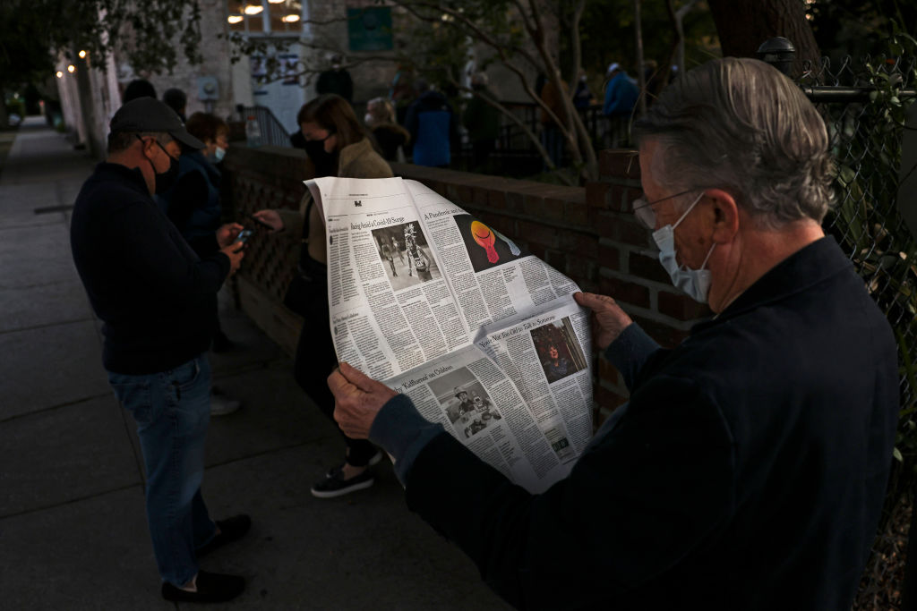 John Winthrop reads a newspaper in line as he waits to vote at the Hazel Parker Playground on Election Day on November 3, 2020 in Charleston, South Carolina. (Michael Ciaglo—Getty Images)