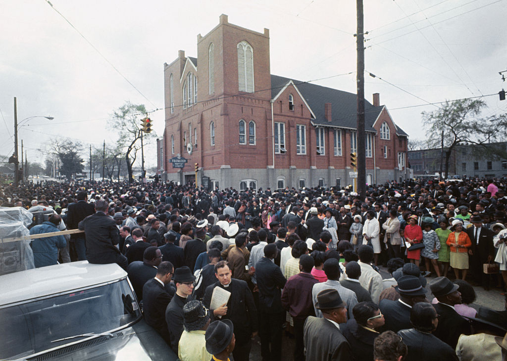 Thousands of funeral marchers gathered outside Ebenezer Baptist Church prepare to walk five miles to Morehouse College where another service for the slain Dr. Martin Luther King, Jr., will be held, April 9, 1968. (Bettmann Archive)