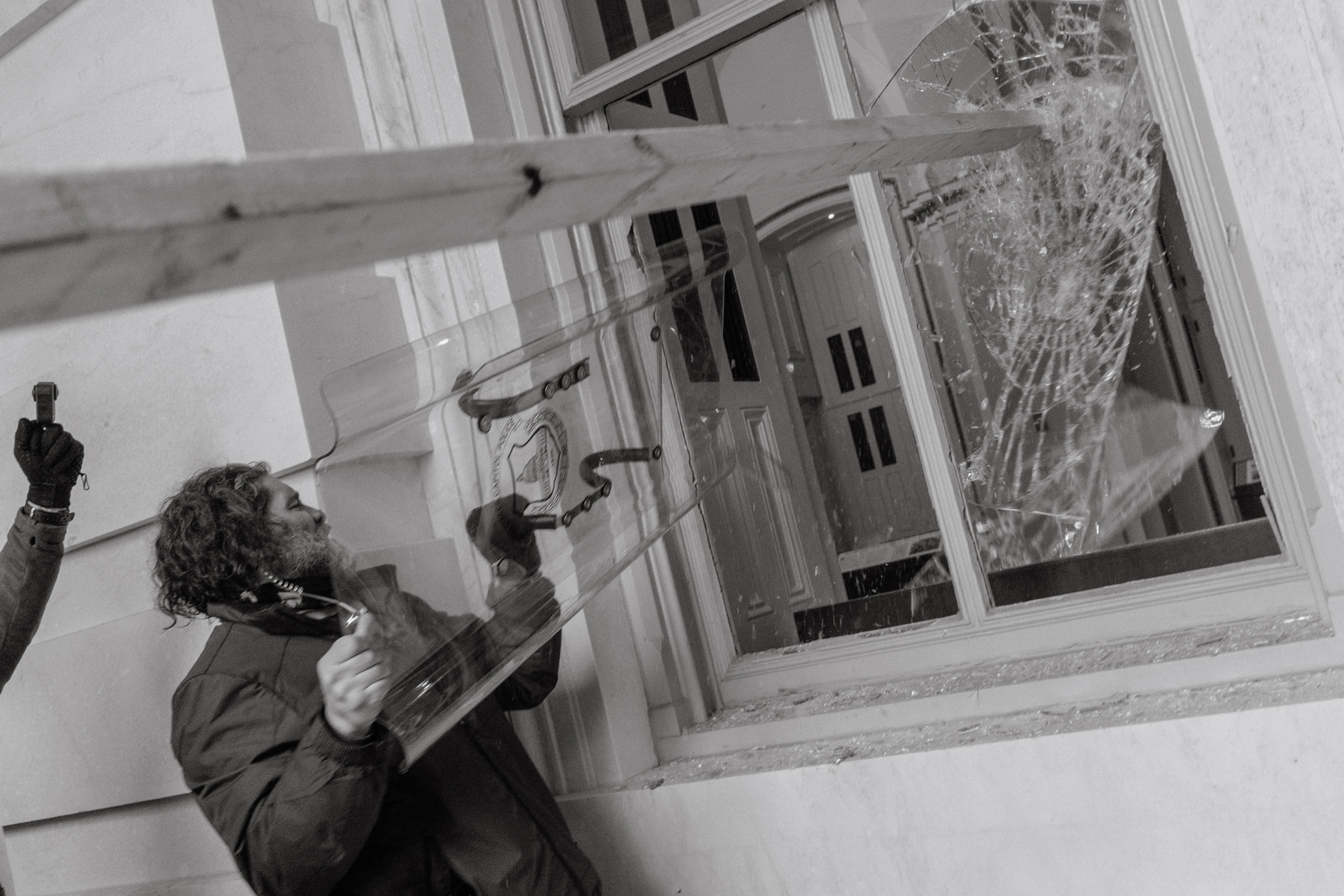 Pro-Trump rioter uses a Capitol Police shield to break a window of the U.S. Capitol in Washington, D.C. (Christopher Lee for TIME)