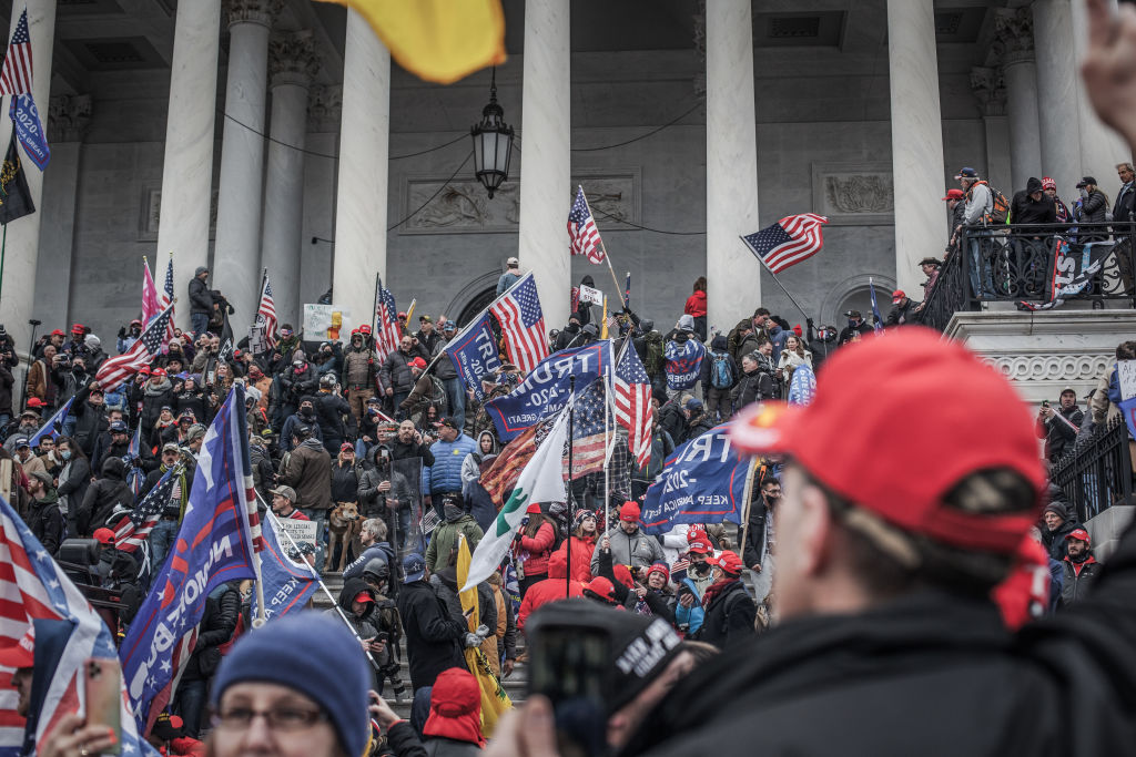 Trump supporters take the steps on the east side of the US Capitol building on January 06, 2021 in Washington, DC.