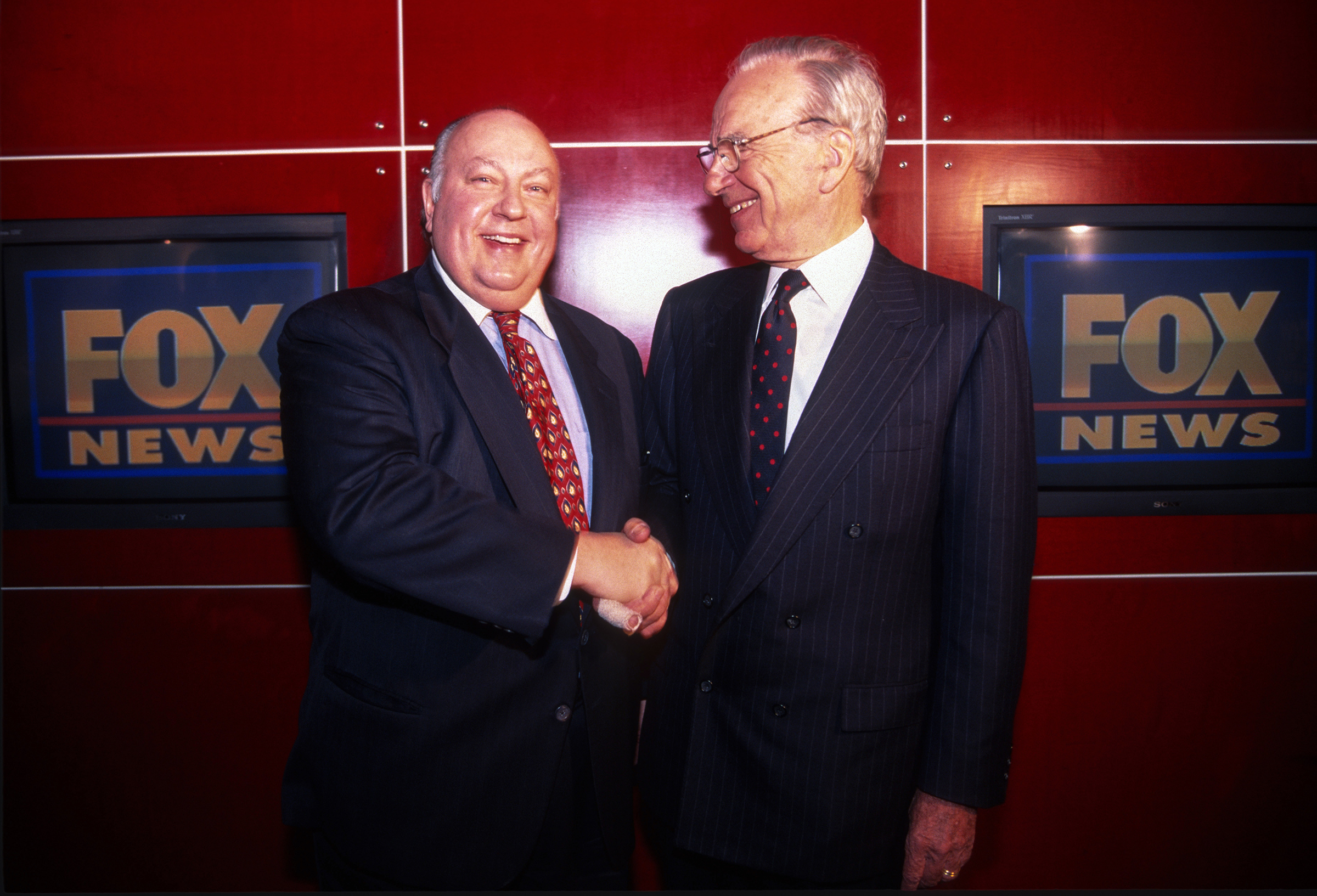 Rupert Murdoch shakes hands with Roger Ailes after naming Ailes the head of Fox News in New York City, Jan. 1996