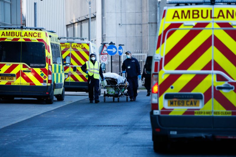 Medical staff wheel a patient on a stretcher to an ambulance outside the emergency department of the Royal London Hospital in London, England, on January 25, 2021.