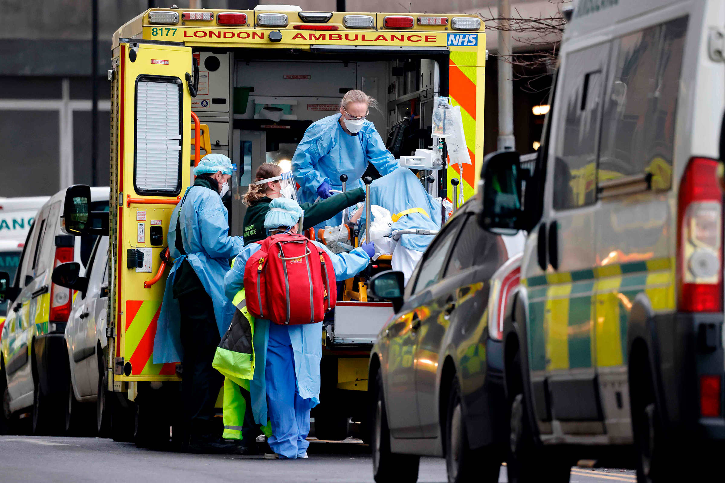 A patient is taken from an ambulance by staff wearing PPE equipment at the Royal Free Hospital, London, on Jan. 11 as surging cases of Covid-19 are placing health services under increasing pressure (Tolga Akmen—AFP/Getty Images)