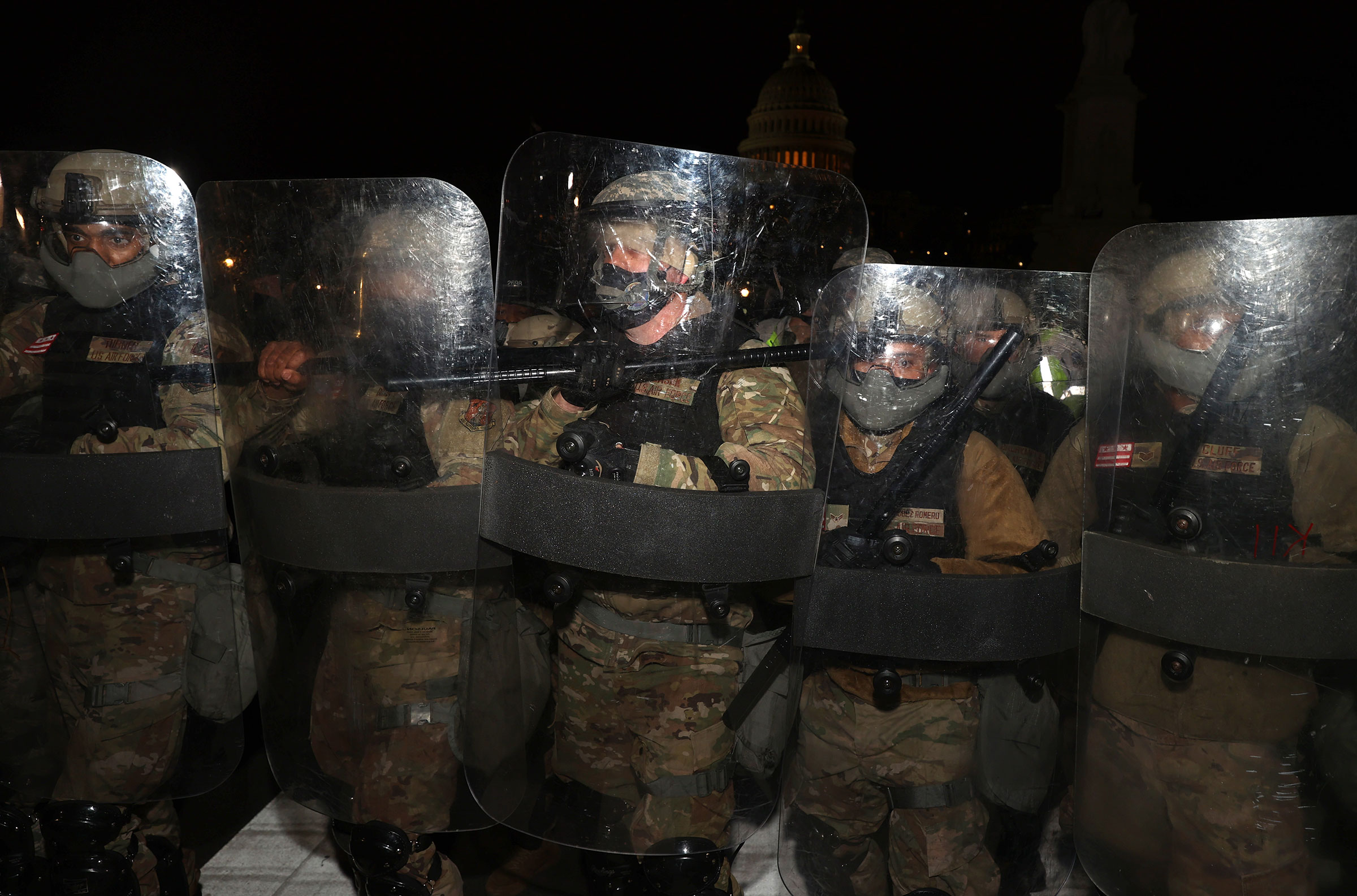 Members of the National Guard assist police officers in dispersing protesters who are gathering at the Capitol Building in Washington, on Jan. 06, 2021.