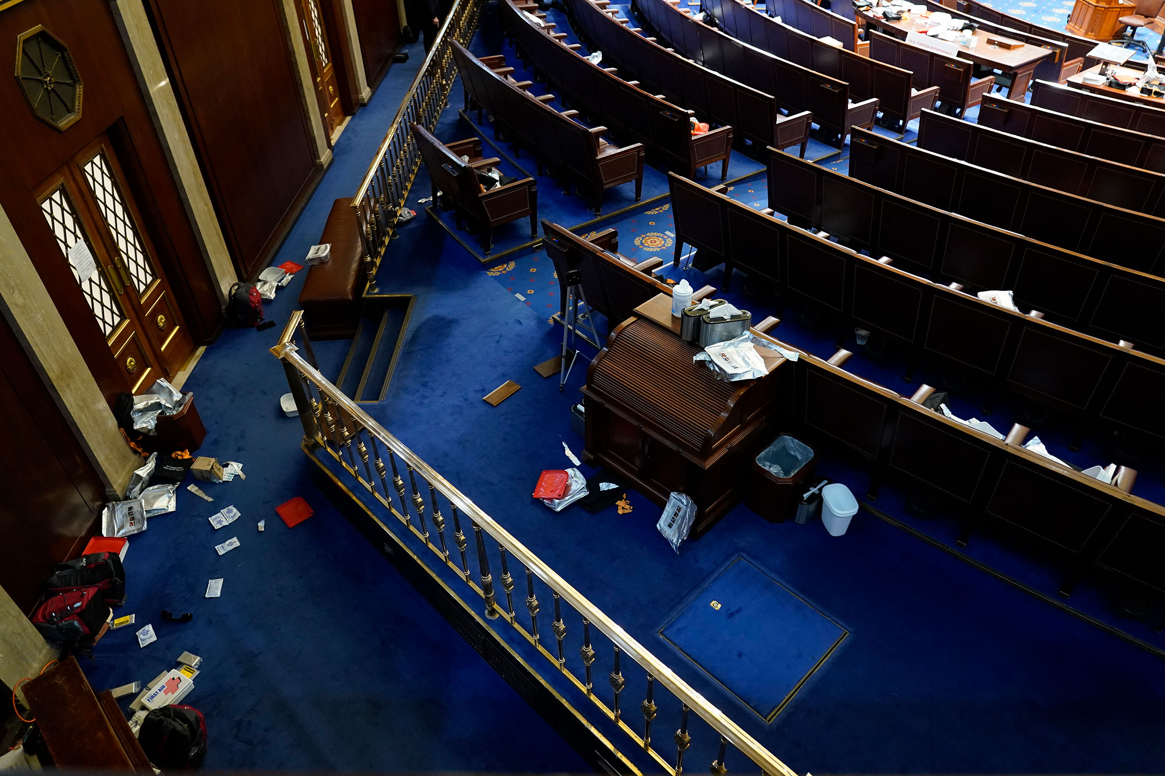 Papers and other materials litter the chamber after House were evacuated as protesters try to break into the House Chamber on Jan. 6, 2021.