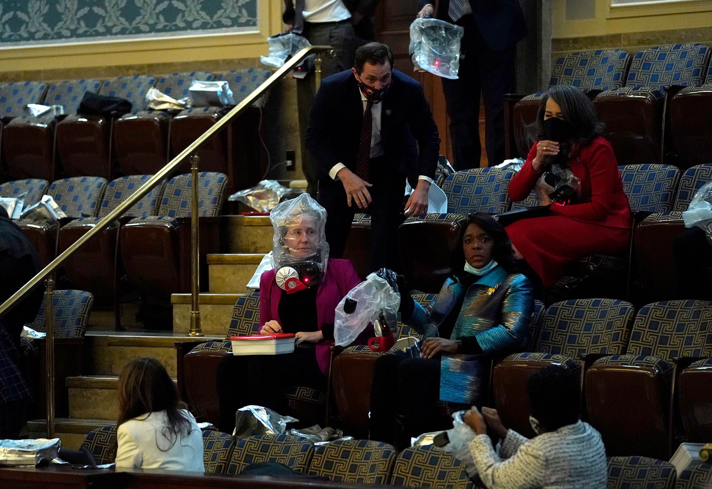 People put on gas masks while sheltering in the House Chamber. (Drew Angerer—Getty Images)