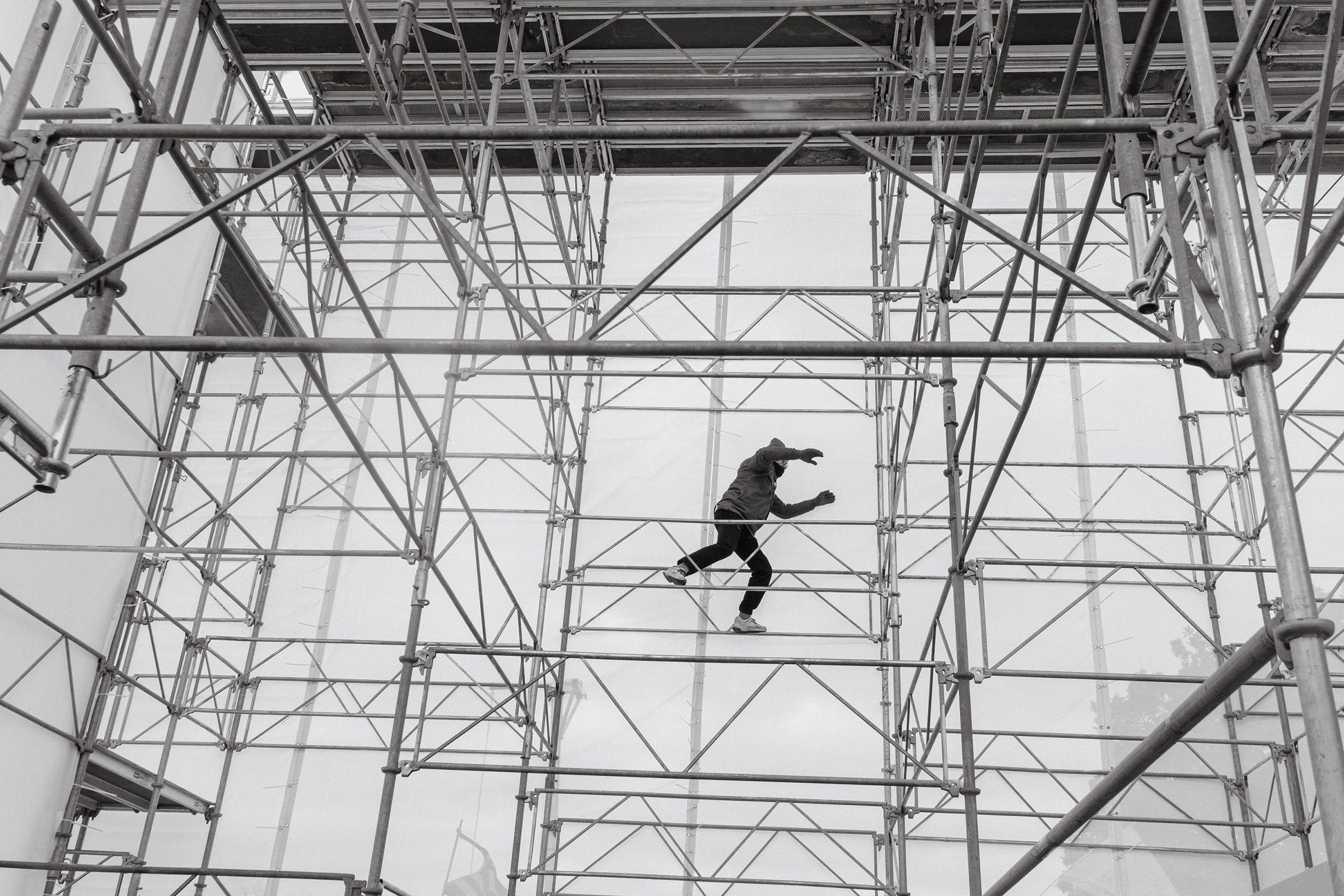 A pro-Trump rioter climbs the scaffolding outside of the Capitol. (Christopher Lee for TIME)