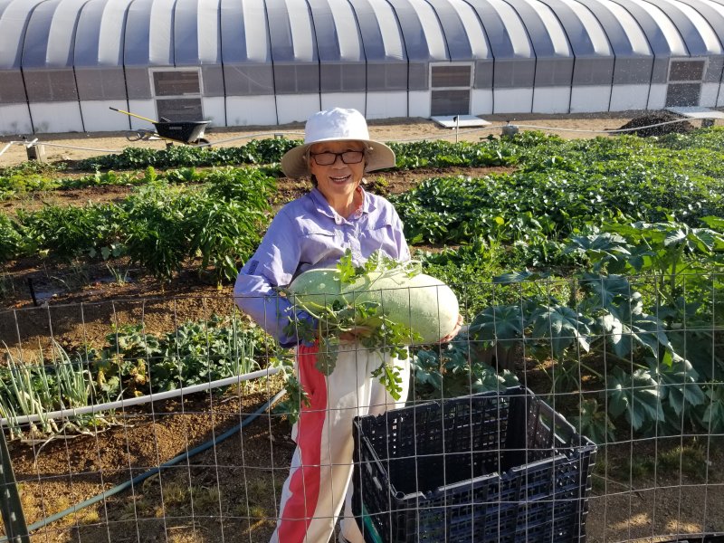 Ran Hee Paeng with a watermelon she grew in Lucerne Valley, Calif.