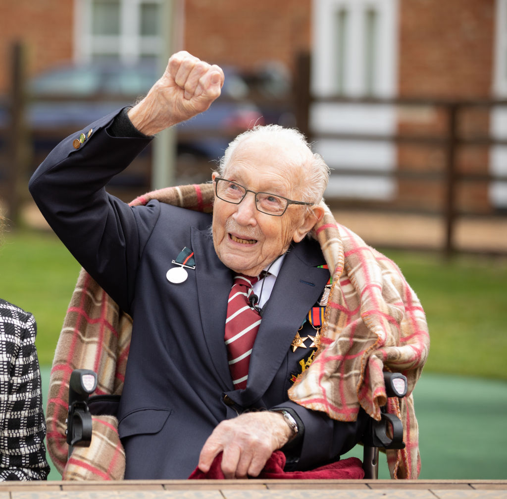 Colonel Tom Moore celebrates his 100th birthday on April 30, 2020 with an RAF flypast provided by a Spitfire and a Hurricane over his home in Marston Moretaine, England (Emma Sohl—via Getty Images)