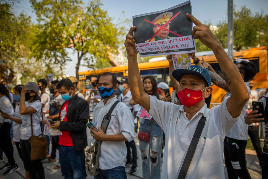 Myanmar protesters hold photos of General Min Aung Hlaing while calling for the end of the Myanmar military coup outside the United Nations headquarters for Southeast Asia on February 03, 2021 in Bangkok, Thailand (Lauren DeCicca—Getty Images)