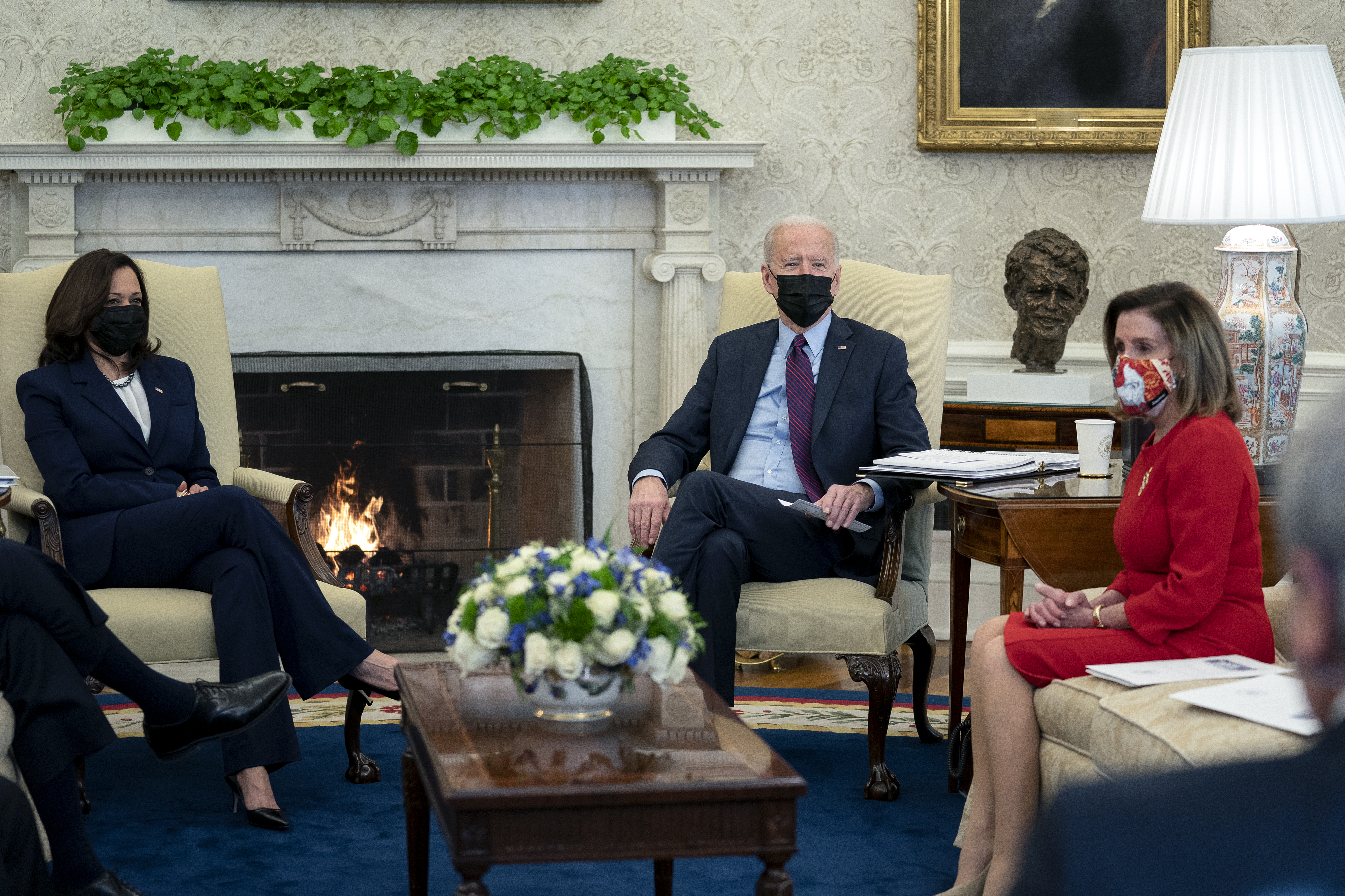 President Joe Biden, center, U.S. Vice President Kamala Harris, left, and U.S. House Speaker Nancy Pelosi, a Democrat from California, wear protective masks during a meeting in the Oval Office of the White House in Washington, D.C., U.S., on Friday, Feb. 5, 2021. The Senate voted 51-50 to adopt a budget blueprint for Biden's $1.9 trillion virus relief package following nearly 15 hours of wading through amendments from both parties. (Stefani Reynolds—The New York Times/Bloomberg/Getty Images)