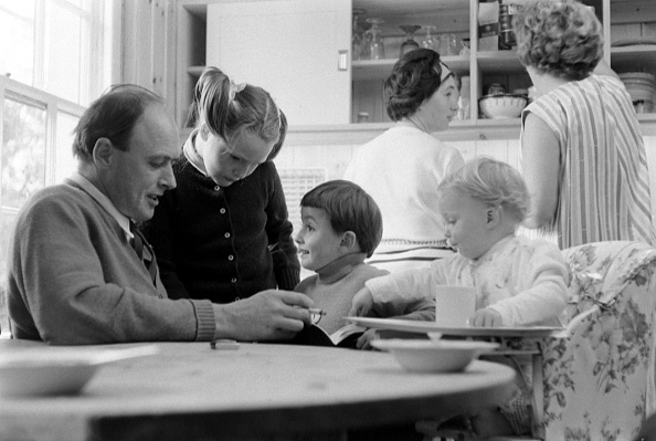 Roald Dahl reads to three of his children, from left, Tessa, Theo, and Ophelia, in the kitchen of his home in Great Missenden, Buckinghamshire, England in September 1965. (Leonard McCombe—The LIFE Picture Collection/Getty Images)