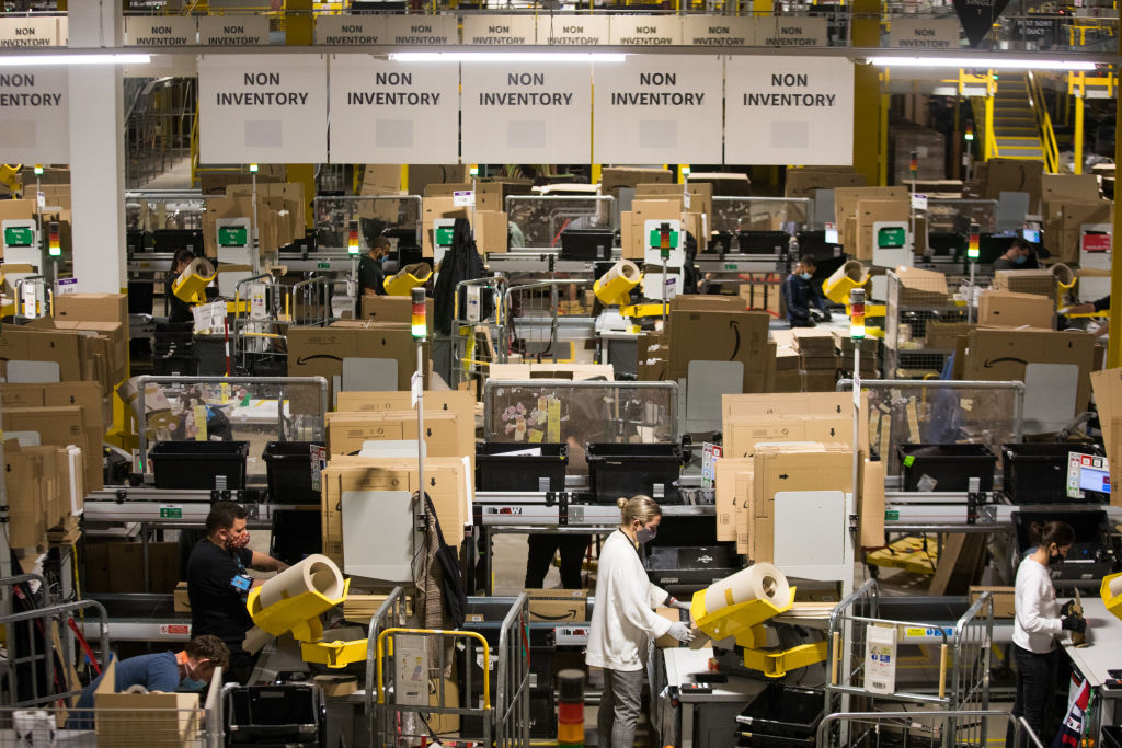 Employees pack goods ready for distribution at an Amazon.com Inc. fulfillment center in Kegworth, U.K., on Monday, Oct. 12, 2020. (Chris Ratcliffe/Bloomberg via Getty Images)