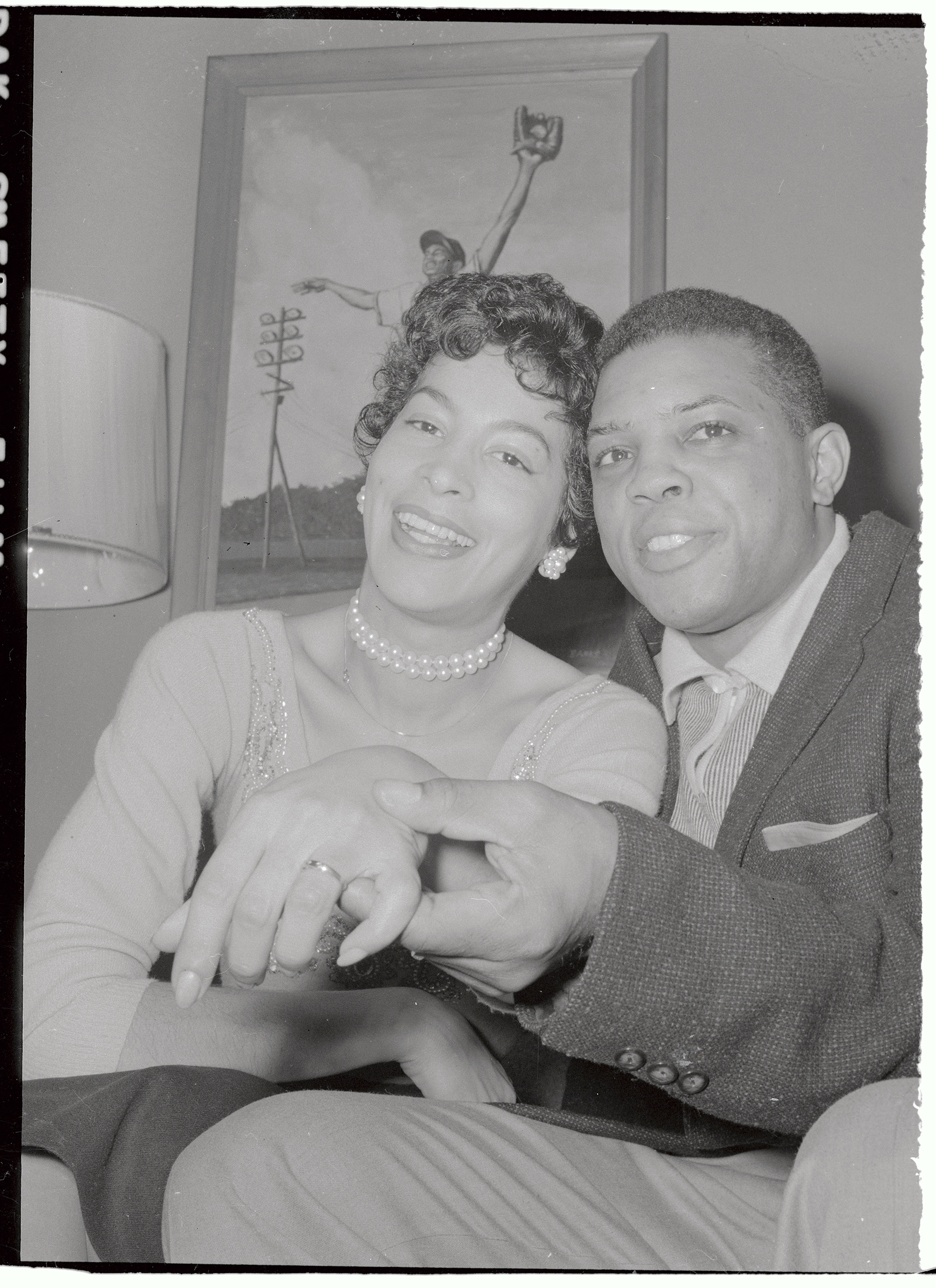 New York Giants star outfielder Willie Mays, 25, is shown with his bride of a few hours, Marguerite Wendelle, 27, at her home in Elmhurst, N.Y. after their wedding in Elkton, Md. on Feb. 14, 1956. En route to Elkton, Mays was arrested for driving 70 miles an hour on the New Jersey turnpike and paid a $15 fine.