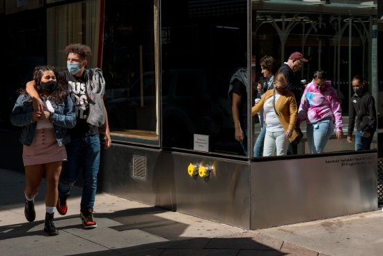 People wearing masks walk in Midtown Manhattan, at 45th st, and 5th ave on Oct. 3, 2020.