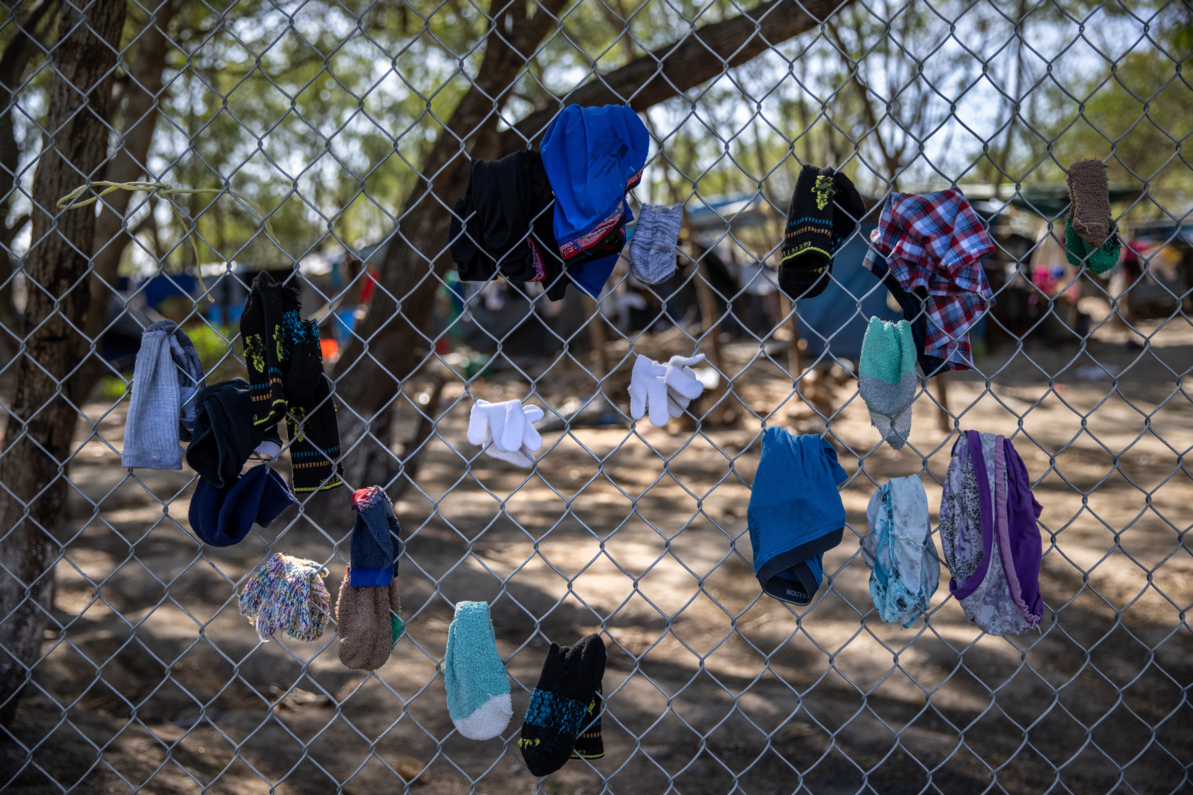 Clothing drying on a fence at a camp for asylum seekers in Matamoros, Mexico, on Feb. 7, 2021. (John Moore—Getty Images)