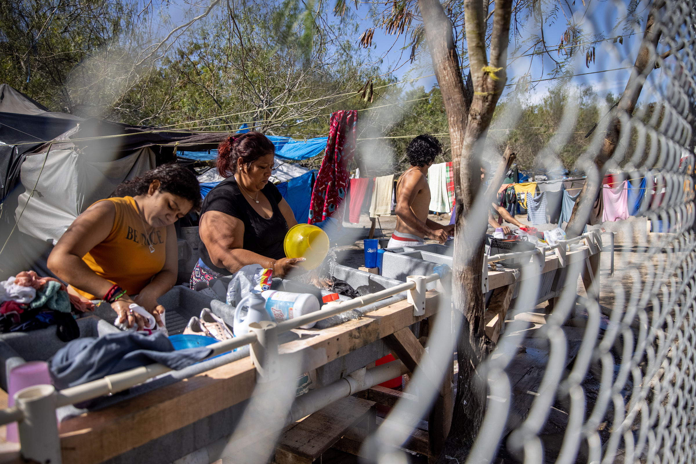 Asylum seekers washing clothing inside a camp in Matamoros, Mexico on Feb. 7, 2021. (John Moore—Getty Images)