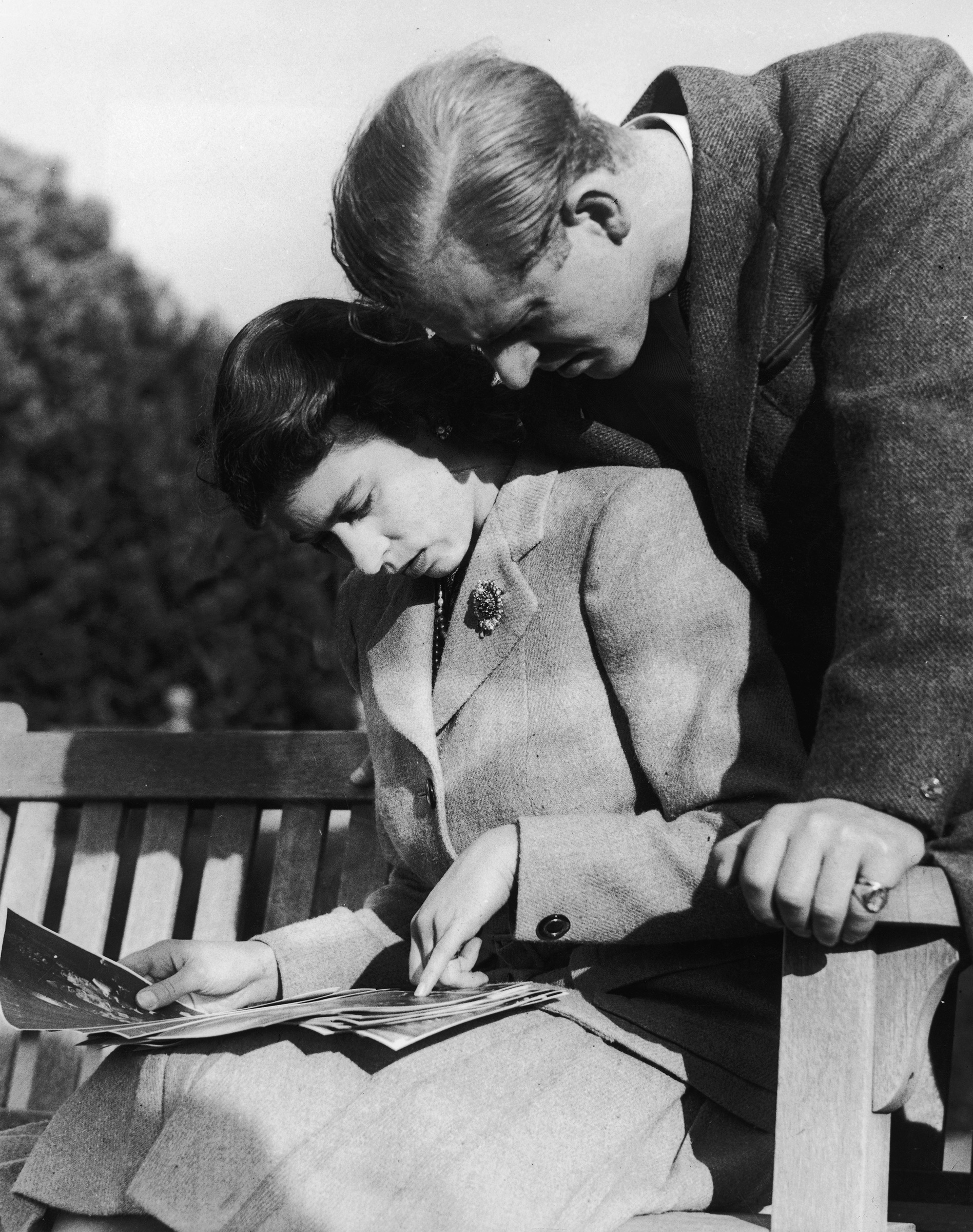 Princess Elizabeth and Philip Mountbatten look at their wedding photographs while on honeymoon in Romsey, Hampshire, Nov. 1947.