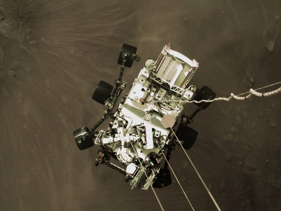 The Perseverance rover is lowered to the surface of Mars on Feb. 18 in image captured by the spacecraft's descent stage. (NASA/JPL-Caltech)